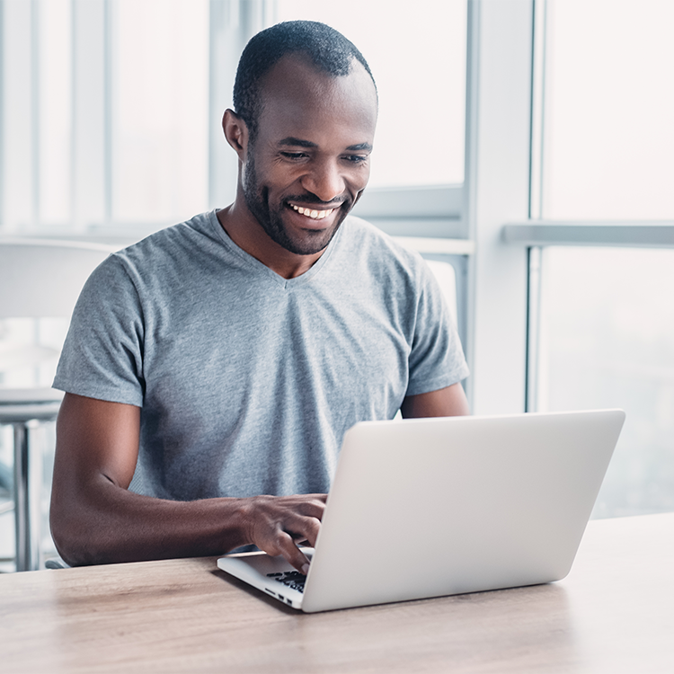 Young businessman working on his laptop in spacious bright office.